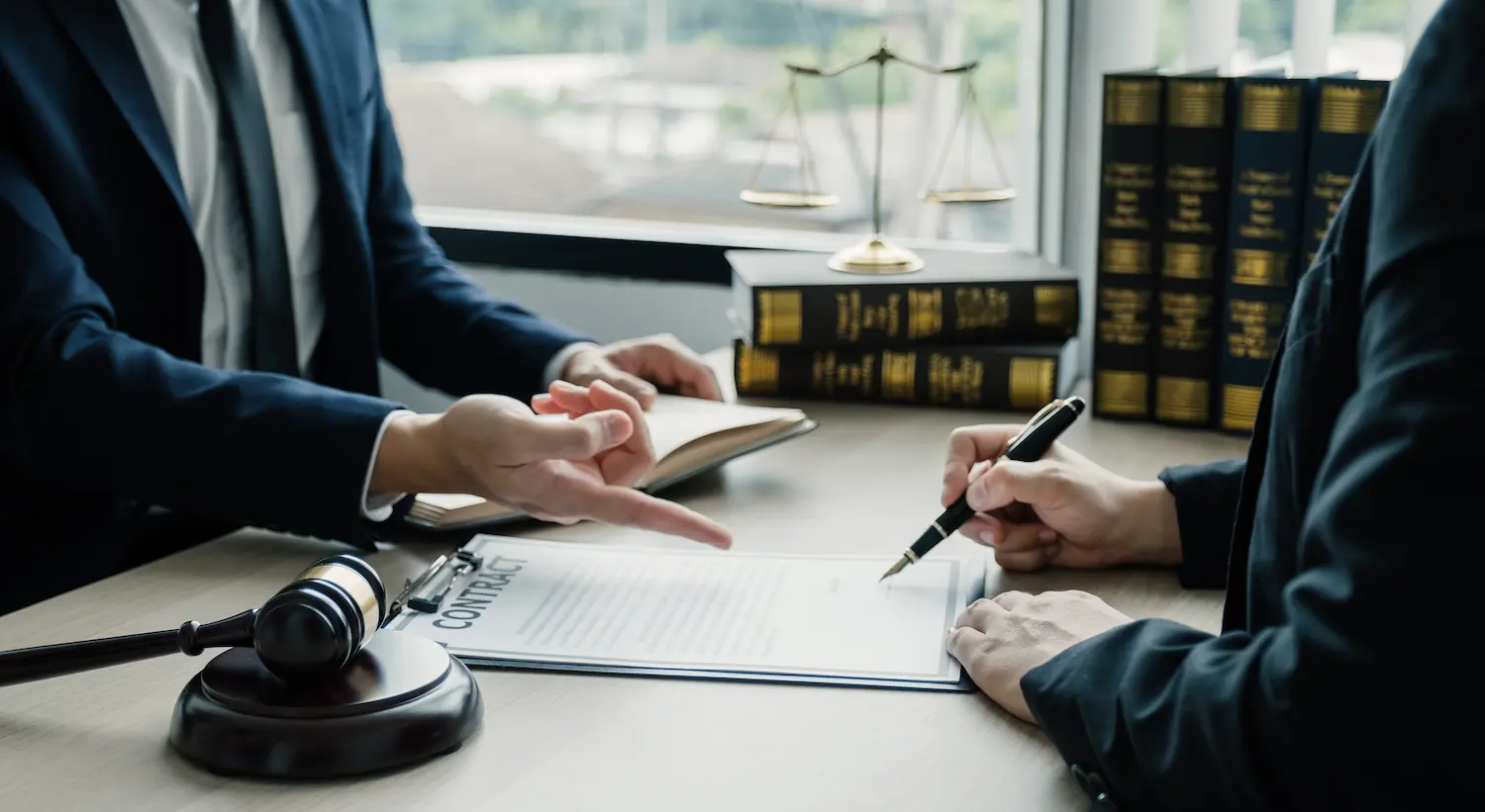 lawyer working with client on an agreement at Real Divorce Solutions.