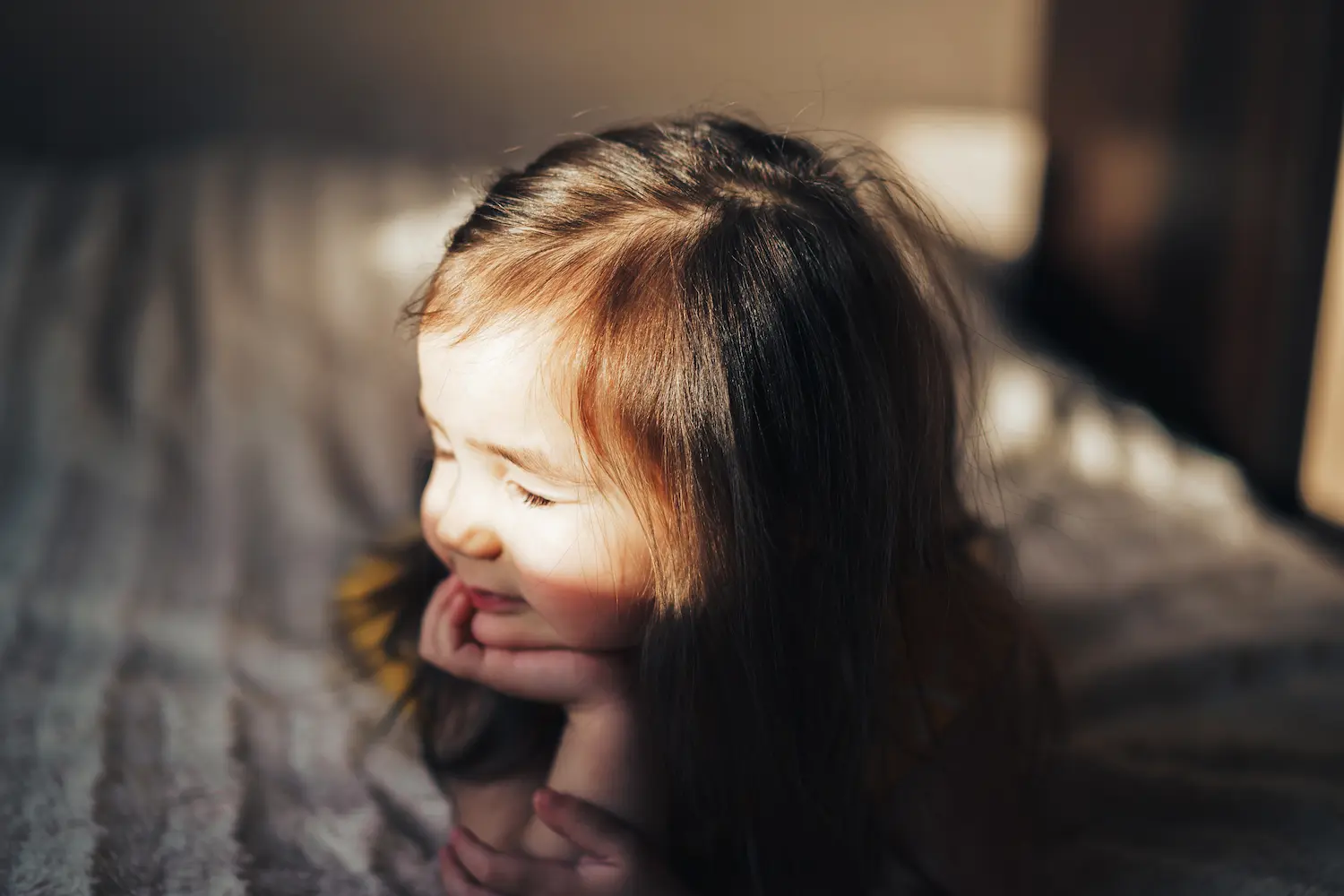 A happy girl safe in her home.